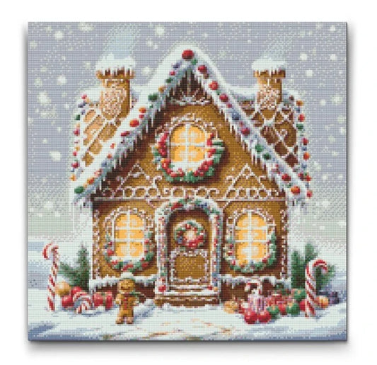 diamond painting af peberkagehus dækket af sne og slikdekorationer, ideel til jul
